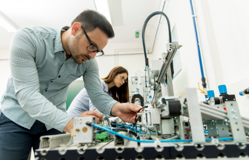 Engineers assembling and testing an electronic and mechanical device at Senologic