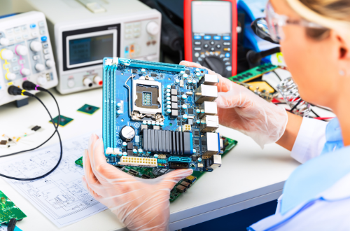Engineer inspecting electronic hardware with multimeter, power supply, and oscilloscope for prototyping
