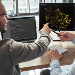 Engineers analyzing data visualizations to represent AI engineering and machine learning development