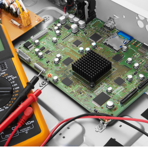 FPGA hardware and multimeter representing digital logic design and signal verification